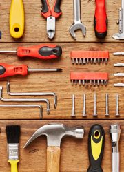 Directly above flat lay shot of various hand tools. Full frame shot of carpentry equipment on wooden floor. They are representing the concept of DIY. Knolling concept.